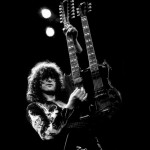 Jimmy Page playing guitar on stage