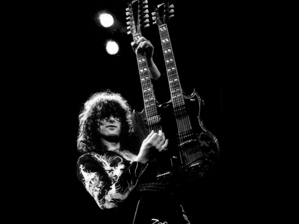 Jimmy Page playing guitar on stage