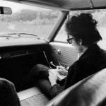 Bob Dylan writing lyrics in a car