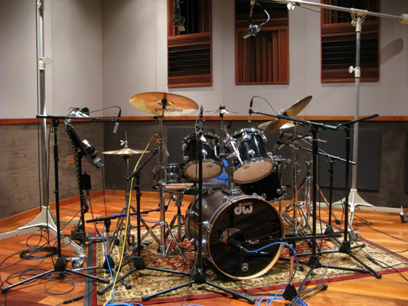 Drum kit with microphones in studio