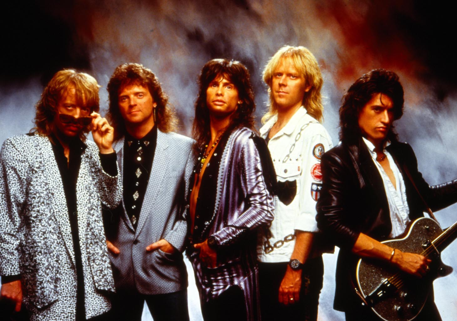 Very tan Aerosmith band members from the 80's