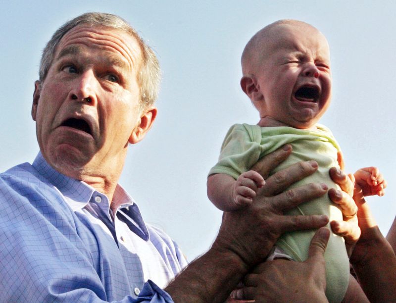 George W. Bush holding crying baby