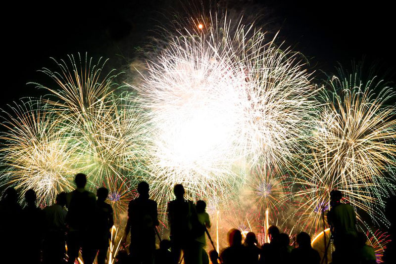 Fireworks, people in foreground, explosions